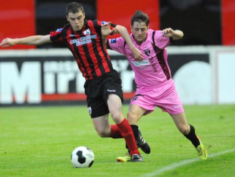 Longford Town defender Noel Haverty wins the ball in this tussle with a Wexford Youths opponent. Action from the recent Airtricity League Division One game at City Calling Stadium. Photo: Declan Gilmore Photography
