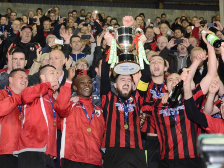 Delighted Longford Town club captain Mark Salmon raises the First Division league trophy amid jubilant scenes at City Calling Stadium on Friday night last. Photo: Declan Gilmore Photography