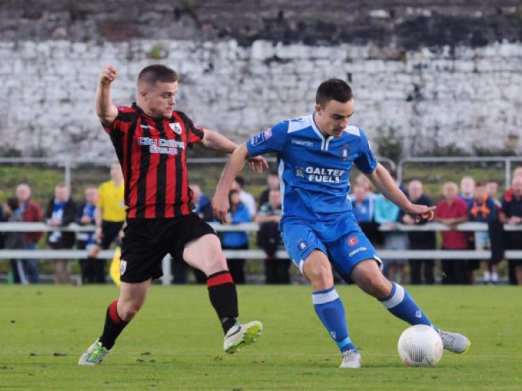 Longford Town player Lorcan Shannon in a tussle with Limerick FC opponent Shane Tracy in the league game at the Markets Field. Photo: Gareth Williams
