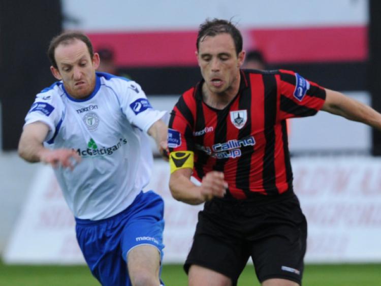 Stephen Rice on the ball for Longford Town in this tussle with Finn Harps opponent Michael Funston. Action from the Airtricity League First Division game at City Calling Stadium on Saturday night last. Photo: Kevin Leavy