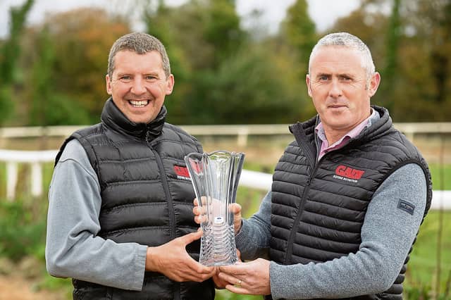 Philip Gilligan (right) of GAIN Equine Nutrition presents Longford trainer Paul Flynn, with the 2024 GAIN The Advantage Series trophy Picture: Finbarr O'Rourke