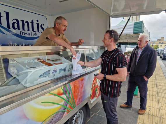 Michael Menton of Atlantis Fresh Fish with customers Damien McKenna from Ballinamuck, and Michael Maloney from Moydow