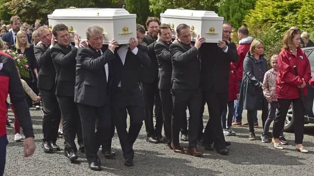 The coffins of mother and daughter Aisling Moore and Abbigael Moore-Tournié being carried from Our Lady Help of Christians Church, Swinford (Pic: Conor McKeown)