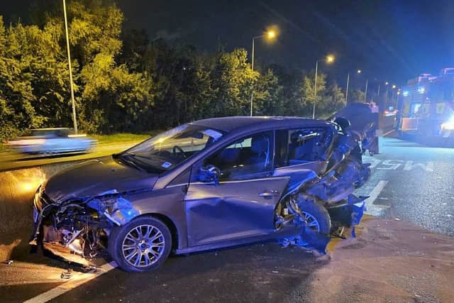 A car that had broken down was struck from behind at high speed. Luckily, the occupants were no longer in the car at the time.