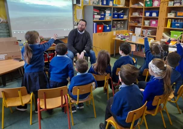 Lee Williamson, owner of the local Shuttermaniac Productions, with the pupils of Lanesboro Primary School