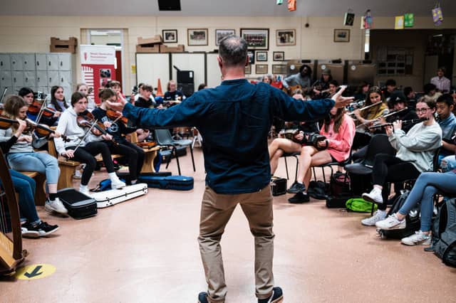 Musical director Sid Peacock leading the young musicians in Creative Sounds