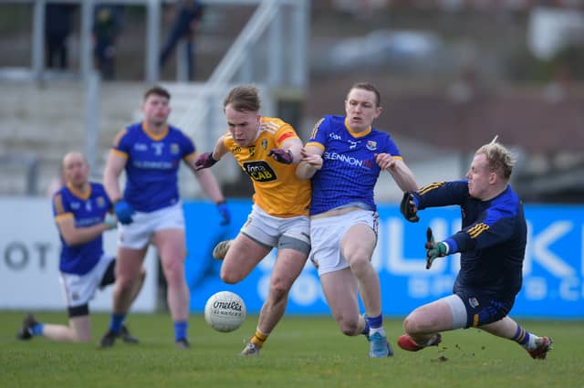 Longford defender Patrick Fox and keeper Paddy Collum trying to stop Antrim attacker Odhran Eastwood in this goal chance Photo: Ken Keenan
