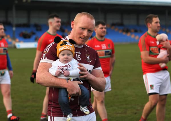 Mullinalaghta St Columba's player Cian Mackey with his son CJ during the parade prior to the Peter Hanley Motors Longford SFC Final in Glennon Brothers Pearse Park Picture: Syl Healy