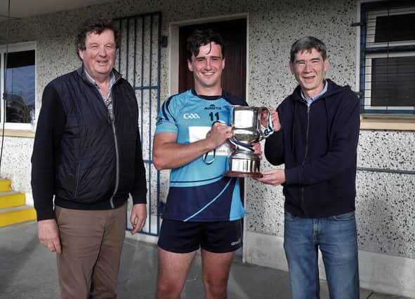 John Duignan presenting the JJ Duignan Cup to Slashers captain Cian Kavanagh along with Longford GAA Chairperson Albert Cooney Photo: Syl Healy