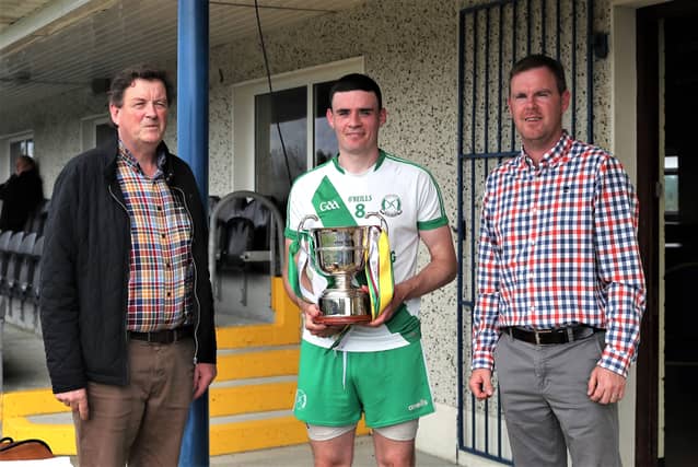 Killashee captain Michael Farrell with the Hennessy Cup along with Chairperson Albert Cooney & sponsor Niall Mulleady Pic: Syl Healy