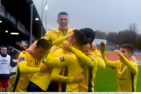 Michael McDonnell, top, of Longford Town celebrates with team-mates after Rob Manley scored their first goal during the SSE Airtricity League Play-off Final match between Shelbourne and Longford Town