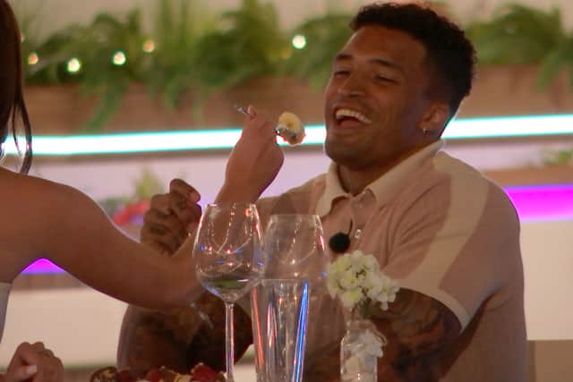 Maura wants to respond to the girls’ heckling but keeps her cool. While the girls continue to laugh and joke from the terrace, she says to Michael “I’ll give them something to talk about.” Maura then feeds Michael some of their dessert.