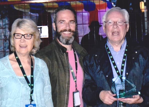 John Drover (centre), President Newfoundland Folk Arts Society presented Aidan O'Hara with his Lifetime Achievement Award. Aidan's wife, Joyce, is on left.
