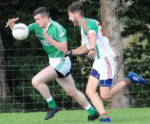 Darren Quinn surging forward for Clonguish ahead of Mostrim opponent Daniel Connell. Action from the SFC Group 1 game in Granard on Sunday evening. Photo: Declan Gilmore