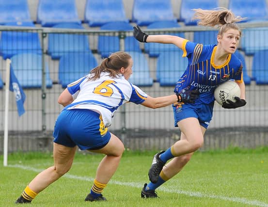 Longford's Niamh Feeney attempts to evade the clutches of Wicklow's Sarah Hogan during the TG4 Ladies Football Leinster Intermediate Championship semi-final. Photo by Declan Gilmore