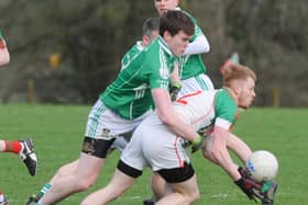 Shane Sheridan on the ball for Mostrim in this tussle with Clonguish opponent Peter Hanley. Action from the All County Football League Division 1 game at Devine Park. Photo: Declan Gilmore