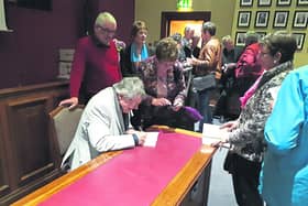 Noel Monahan signs copies of Chalk Dust following the poetry collection's launch by Dr Niall McMonagle at Cavan Courthouse last week.