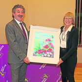 Angela Tuite presents painting to Minister John Halligan at the launch of Science Week in Edgeworthstown