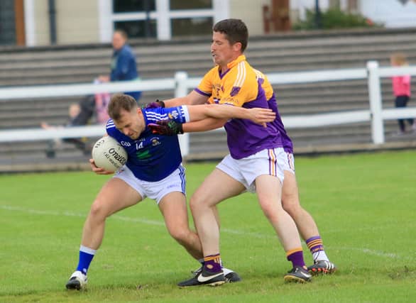 Shane Cox on the attack for Legan Sarsfields in this tussle with Young Grattans defender Damian McHugh. Action from the Intermediate Football Championship first round game last weekend. Pic: Syl Healy