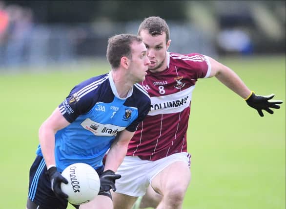 Andrew Dalton on the ball for Longford Slashers in this tussle with Mullinalaghta St Columba's opponent David McGivney in the Senior Football Championship first round game. Photo: Declan Gilmore