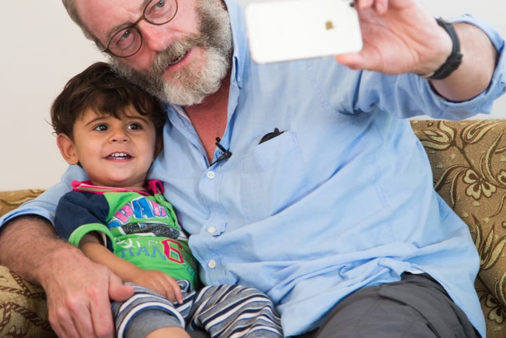 Games of Thrones actor Liam Cunningham with  Syrian refugee child in Jordan.