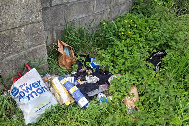 Illegally dumped bags of household waste and clothes