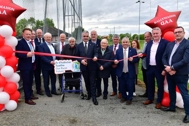 Minister for Rural and Community Development and the Gaeltacht, Dara Calleary TD cutting the ribbon to officially open the new walkway, located on the grounds of Fr Leo Casey Park, home to Ballymahon GAA which was funded by the Department through the CLÁR programme