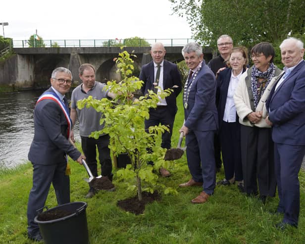 At the tree-planting ceremony in The People’s Park, Ballymahon, marking 25 years of twinning between Ballymahon and Landévant in Brittany, France, were (left to right): Mayor of Landévant Pascal Le Calvé, Derrick Healy of Creative Design Garden Centre, Cllr Paul Ross, Ballymahon Municipal District Cathaoirleach Martin Skelly, Chairperson of Landévant Twinning Claude Jean-Pierre, Chairperson of Ballymahon Twinning Breege Murray, Fabienne Le Calvé of Landévant and Cllr Pat O’Toole. At the rear are Senator Paraic Brady and Longford County Council Chief Executive Paddy Mahon. 