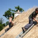 Master Thatcher Tom O'Byrne and his son Oisin in Longford recently rethatching a roof 