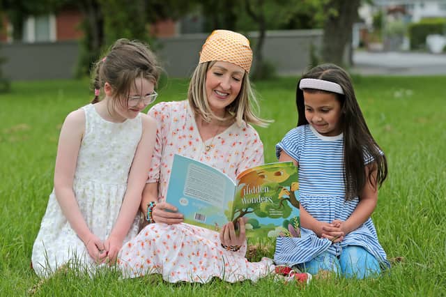 One of the authors of Hidden Wonders, Shelley Corcoran, reads to Heidi and Sara