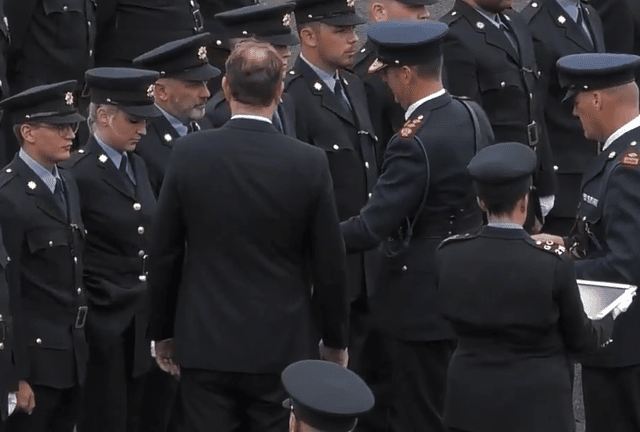 Garda Donal Harrington receiving his formal Garda identification from Justice minister Jim O'Callaghan