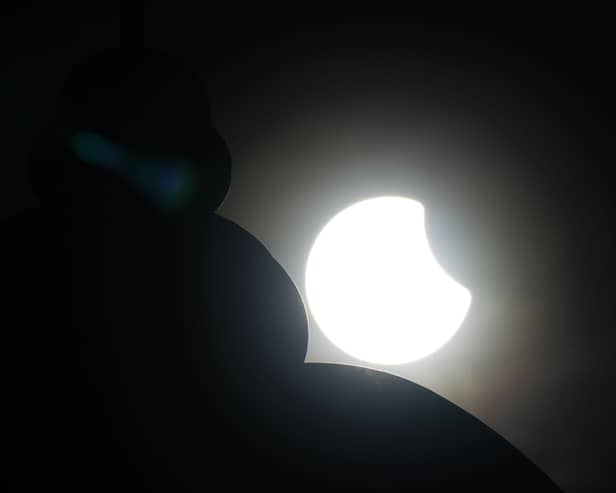 A partial solar eclipse is seen behind the domed roof of the foot tunnel. File.