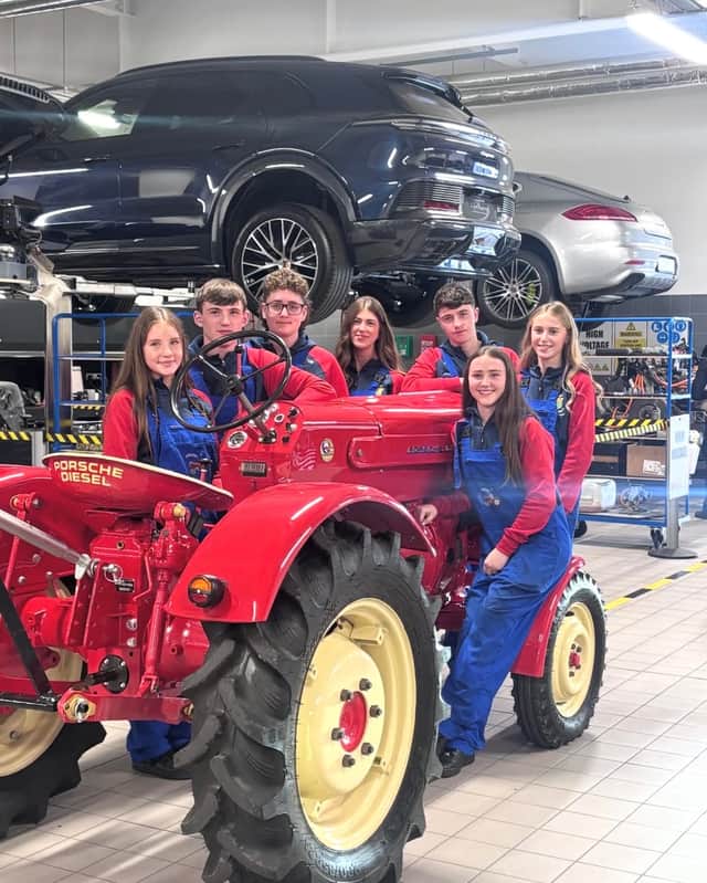 The Mercy Ballymahon TY Projekt Porsche Team pictured with their restored tractor in Porsche Dublin: Lilly Duggan Finn, Fionn Cox, Tadhg O’Rourke, Holly Fahy, Turlough Tiernan, Freya White, and Ellie O’Hanlon.