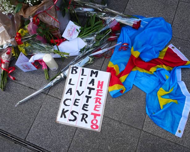 Flowers at a vigil for Yves Sakila on Henry Street in Dublin