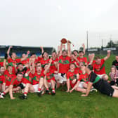 Mostrim captain Jack Belton lifting the Hennessy Cup as the victorious Edgeworthtown players celebrate their Intermediate Championship triumph Photo: Syl Healy 