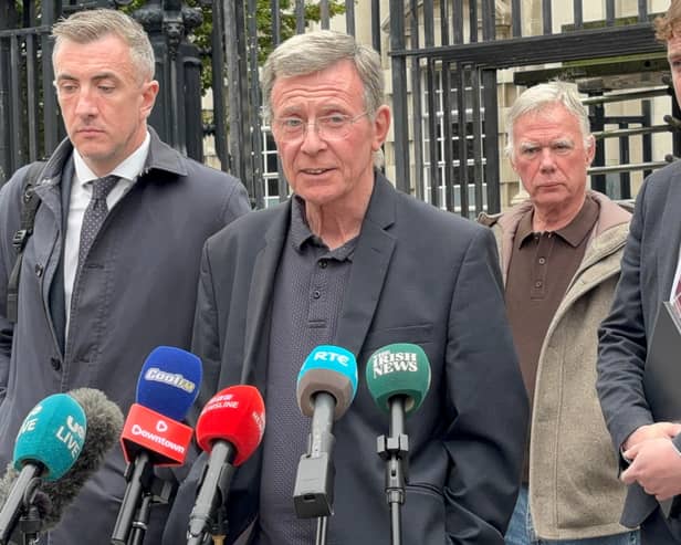 Breandan Mac Connaith speaking to the media flanked by three other men
