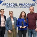 Award winning athlete Erin pictured at this years awards ceremony with her parents, Clare and Joe, and school coach, Ms Magan. 