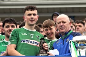 Lethal Clonguish attacker Michael Flynn receiving the Man of the Match Award (Fr Phil McGee memorial trophy) from Longford GAA Chairperson Derek Fahy  Photo: Syl Healy 