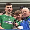 Lethal Clonguish attacker Michael Flynn receiving the Man of the Match Award (Fr Phil McGee memorial trophy) from Longford GAA Chairperson Derek Fahy  Photo: Syl Healy 