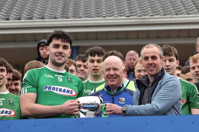 Clonguish captain Matthew Carey receiving the Sean Connolly Cup from David Hanley (sponsor, Peter Hanley Motors) and Longford GAA Chairperson Derek Fahy Photo: Syl Healy