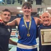 Edgeworthstown boxer Tommy Stokes pictured with his coaches Joe Ward and Rory Parkes (right)
