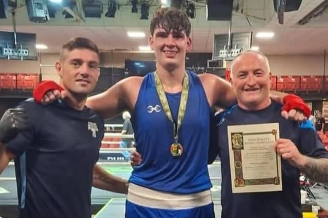 Edgeworthstown boxer Tommy Stokes pictured with his coaches Joe Ward and Rory Parkes (right)