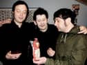 Irish singer-songwriter Shane MacGowan, the original lead vocalist of the Pogues, flanked by brothers Johnny Cronin and Mick Cronin