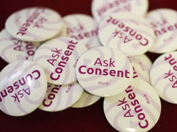 Badges with the words 'ask consent' on the front