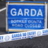 Garda crime scene tape and road closed sign