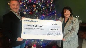 Michael Flatley presents Mary Gamble of Barnardos with cheque after auction