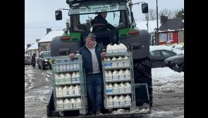 COLD SNAP: Special delivery for shop in snowbound town as milk arrives on back of tractor