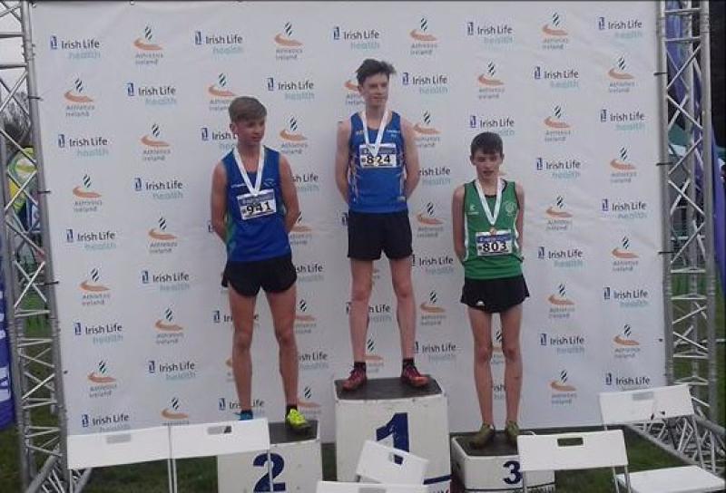 Longford Athletic Club's Cian McPhillips on the podium after he won the Irish Life Health National U-16 Cross Country Championship title at the Sport Ireland National Sports Campus in Dublin