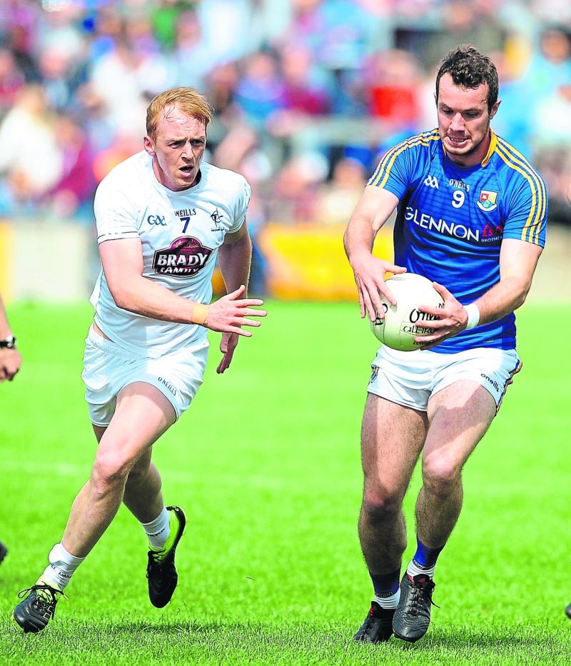 David McGivney on the ball for Longford in evading the challenge of Kildare opponent Keith Cribbin. Action from the Leinster Senior Football Championship quarter-final at O'Connor Park, Tullamore on S