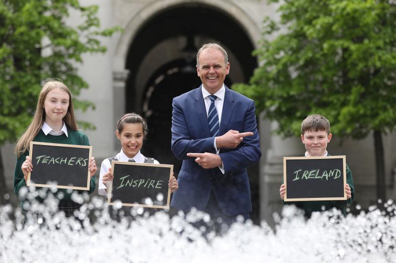 Minister for Education and Skills, Joe McHugh TD, and 4th Class pupils  Max Maples and Leannah McCarthy and Katie O’Brien,